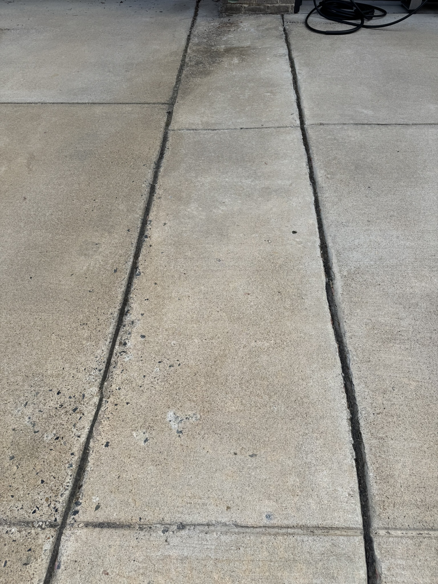 Dark stained concrete pads before cleaning